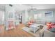 Open living space features hardwood floors, a comfortable couch, and lots of natural light at 3007 Avenue E # A, Holmes Beach, FL 34217