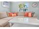 Inviting living room with a large sectional sofa, decorative pillows, and a bright window at 3007 Avenue E # A, Holmes Beach, FL 34217