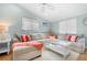 Inviting living room with a large sectional sofa, stylish pillows, and a white coffee table on a patterned rug at 3007 Avenue E # A, Holmes Beach, FL 34217