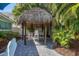 Covered tiki hut with comfortable seating and tropical surroundings for outdoor entertainment at 3007 Avenue E # A, Holmes Beach, FL 34217