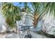 Outdoor patio with a table, chairs, and tropical plants, perfect for relaxing at 3007 Avenue E # A, Holmes Beach, FL 34217