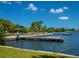 Enjoy waterfront living with community dock featuring covered seating and scenic views of the bay under sunny blue skies at 3015 Gulf Of Mexico Dr # 2, Longboat Key, FL 34228