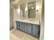 Elegant bathroom featuring a double vanity, marble countertop, modern fixtures and step-in shower at 3504 Estrada St, Sarasota, FL 34239