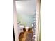 Compact bathroom with a toilet, shower with graphic curtain, granite countertop, and wood-look flooring at 3504 Estrada St, Sarasota, FL 34239
