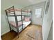 The bunk room features a sturdy metal frame and wood-look floors with a woven mat at 3504 Estrada St, Sarasota, FL 34239