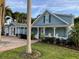 Charming light blue two-story home featuring a welcoming front porch with white Adirondack chairs at 3504 Estrada St, Sarasota, FL 34239