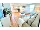 Bright and airy living area with a comfortable sofa, wooden floors, white walls, and a modern kitchenette at 3504 Estrada St, Sarasota, FL 34239