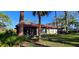 Lush backyard view of the villa, featuring a mix of trees, greenery, and well-maintained grass at 3630 White Pine Ct # 138, Sarasota, FL 34238