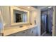 Bathroom vanity featuring a large mirror, quartz countertop, and shower at 3630 White Pine Ct # 138, Sarasota, FL 34238