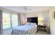 Cozy bedroom featuring a queen bed, ceiling fan, and large window for ample natural light at 3630 White Pine Ct # 138, Sarasota, FL 34238