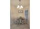 Cozy dining area with a round table and stylish lighting fixture at 3630 White Pine Ct # 138, Sarasota, FL 34238