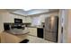 Updated kitchen with stainless steel refrigerator, modern appliances, and ample counter space at 3630 White Pine Ct # 138, Sarasota, FL 34238