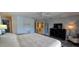 Comfortable main bedroom with a king bed, dresser, and ensuite bathroom at 3630 White Pine Ct # 138, Sarasota, FL 34238