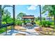 Inviting community grilling area with lush landscaping, providing residents a space to enjoy outdoor cooking at 3630 White Pine Ct # 138, Sarasota, FL 34238