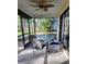 Screened in patio with ceiling fan and glass table at 3630 White Pine Ct # 138, Sarasota, FL 34238