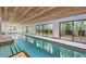 Indoor pool with wood ceiling and sliding glass doors to outdoor at 3977 Roberts Point Rd, Sarasota, FL 34242