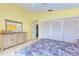 Yellow main bedroom featuring a closet and dresser at 3977 Roberts Point Rd, Sarasota, FL 34242