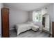 Well-lit bedroom with light-colored wood floors, a large window, and neutral tones at 4415 Natchez Ter, North Port, FL 34287