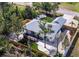 An aerial view of the home with a deck surrounded by green grass and trees at 4661 Alligator Dr, Venice, FL 34293