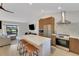 View of the kitchen with stainless appliances, quartz counters, a center island, and eat-in bar at 4661 Alligator Dr, Venice, FL 34293