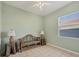 Cozy bedroom featuring tile floors and a light green color palette at 4705 Sweetmeadow Cir, Sarasota, FL 34238