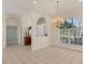 Open-concept dining room featuring tile floors and a chandelier at 4705 Sweetmeadow Cir, Sarasota, FL 34238