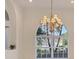 Dining room with a bright window, chandelier and light colored walls at 4705 Sweetmeadow Cir, Sarasota, FL 34238