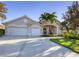 Beautiful single-story home with a well-manicured lawn, three-car garage and inviting entrance at 4705 Sweetmeadow Cir, Sarasota, FL 34238