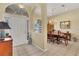 Inviting foyer with arched entryways and dining room featuring chandelier and wood table at 4705 Sweetmeadow Cir, Sarasota, FL 34238