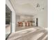 Open-concept kitchen with white cabinets, bar seating, and view to the spacious living area at 4705 Sweetmeadow Cir, Sarasota, FL 34238