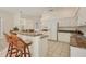 Bright kitchen features white cabinetry, granite counters, and a convenient breakfast bar at 4705 Sweetmeadow Cir, Sarasota, FL 34238