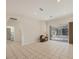 Spacious living room with tile flooring, sliding glass doors, and comfortable chair at 4705 Sweetmeadow Cir, Sarasota, FL 34238