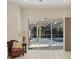 Comfortable living room featuring sliding glass doors opening to a screened pool at 4705 Sweetmeadow Cir, Sarasota, FL 34238