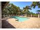 Beautiful community pool surrounded by mature landscaping, a play area, and brick pavers at 4705 Sweetmeadow Cir, Sarasota, FL 34238