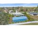 An aerial view of the property showcasing the home, detached garage, landscaping, and surrounding neighborhood at 5002 Bunyan St, Sarasota, FL 34232