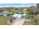 Aerial view of a home with outbuilding and carport and a large driveway at 5002 Bunyan St, Sarasota, FL 34232