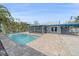 Spacious backyard featuring a sparkling pool, patio area, and lush tropical landscaping, perfect for relaxation at 5002 Bunyan St, Sarasota, FL 34232