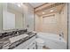 Bathroom featuring a garden tub, decorative tile, and granite sink at 5002 Bunyan St, Sarasota, FL 34232