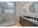 Elegant bathroom showcasing a glass shower, skylight, and a double vanity at 5002 Bunyan St, Sarasota, FL 34232