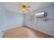 Bedroom featuring tiled floors, ceiling fan and a wall-mounted TV at 5002 Bunyan St, Sarasota, FL 34232