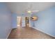 Bedroom featuring tiled floors, ceiling fan and a wall-mounted TV at 5002 Bunyan St, Sarasota, FL 34232