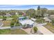Charming single-story home with a metal roof, manicured landscaping, and a detached blue garage at 5002 Bunyan St, Sarasota, FL 34232