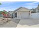 Well-kept home showing the garage door, driveway, and manicured landscaping at 5002 Bunyan St, Sarasota, FL 34232