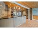 Kitchen with stainless steel appliances, a large island, and stylish lighting fixtures at 5002 Bunyan St, Sarasota, FL 34232