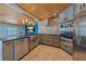 Modern kitchen with stainless steel appliances, stone backsplash, an island, and wood plank ceiling at 5002 Bunyan St, Sarasota, FL 34232