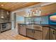 Spacious kitchen with stainless steel appliances, large island, and wood plank ceiling at 5002 Bunyan St, Sarasota, FL 34232