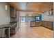 Stylish kitchen showcasing modern cabinets, stone countertops, and views of the backyard at 5002 Bunyan St, Sarasota, FL 34232