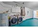 Modern laundry room with a washer, dryer, water heater and ample storage cabinets at 5002 Bunyan St, Sarasota, FL 34232