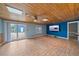 Living room with skylights, ceiling fan, backyard access, and modern media center at 5002 Bunyan St, Sarasota, FL 34232
