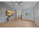 Bright living area featuring a ceiling fan, neutral walls, and wood-look tile flooring at 5002 Bunyan St, Sarasota, FL 34232